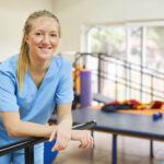 Smiling,Young,Woman,As,Physiotherapist,Standing,In,Gym,Of,Nursing