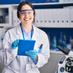 Young,Woman,Scientist,Using,Touchpad,At,Laboratory