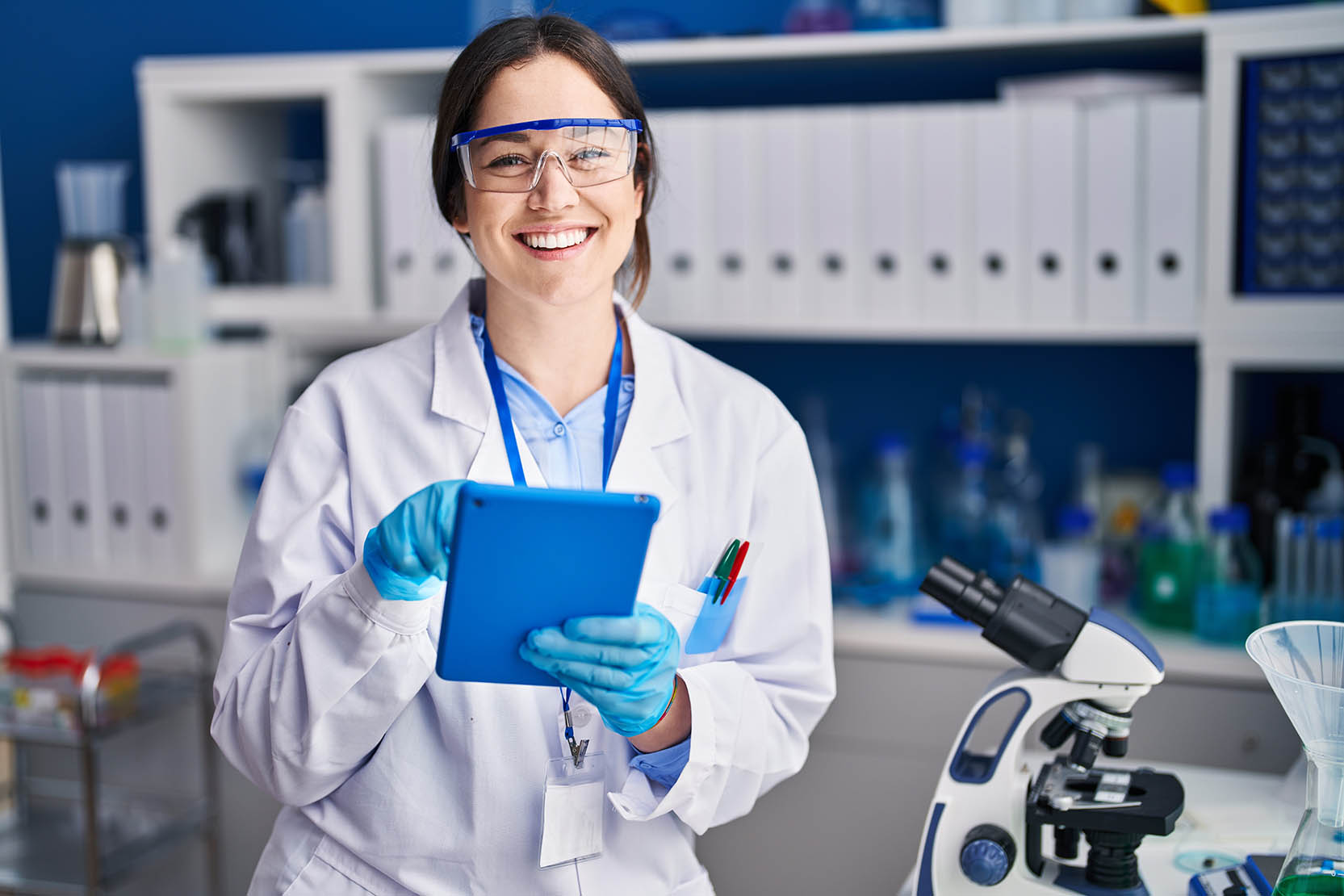 Young,Woman,Scientist,Using,Touchpad,At,Laboratory